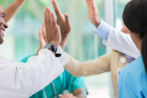 Medical professionals give high fives